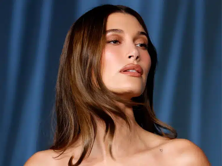 Hailey Bieber Rhode beauty campaign bed photos sheer bra thong heels reactions